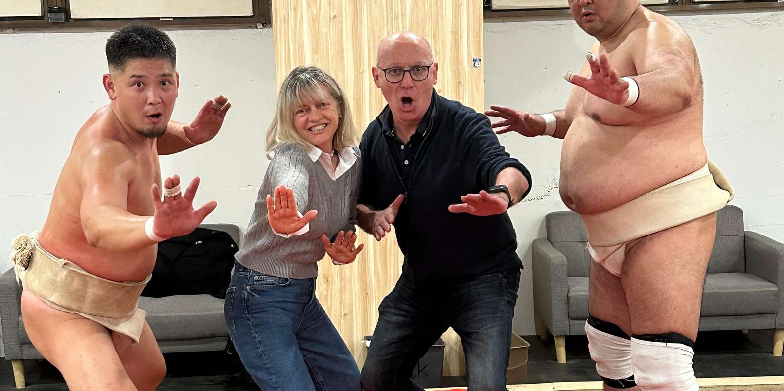 Western tourist wearing traditional sumo mawashi outfit challenging professional wrestler in dohyo ring during interactive Tokyo Shinjuku sumo wrestling experience rated 5 stars by Giorgio from Switzerland